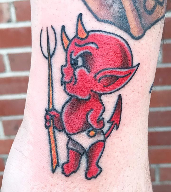 Red cartoon devil tattoo on arm