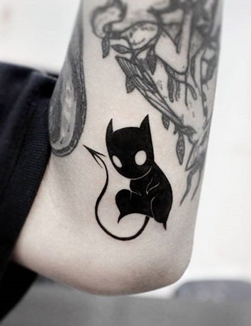 Little cute black devil tattoo on elbow for male