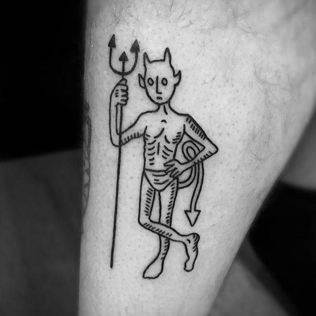 Devil with fork tattoo on elbow